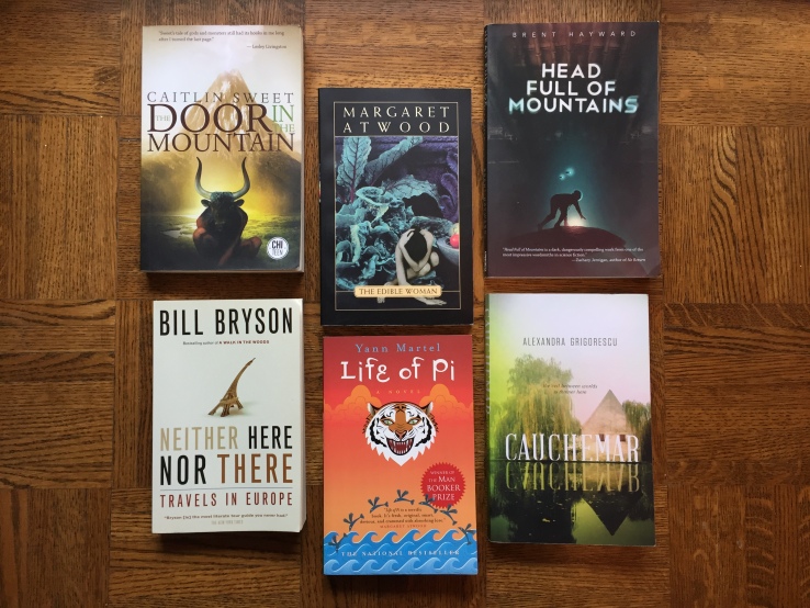 Photo of 6 books: Neither Here Nor There by Bill Bryson, The Life of Pi by Yann Martel, The Edible Woman by Margaret Atwood, The Door in the Mountain by Caitlin Sweet, Head Full of Mountains by Brent Hayward, and Cauchemar by Alexandra Grigorescu.